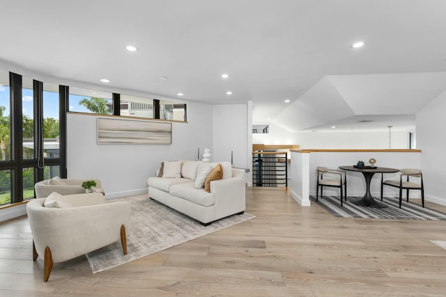 living area with recessed lighting, baseboards, and wood finished floors