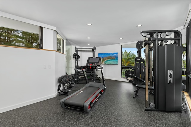 workout area featuring recessed lighting and baseboards