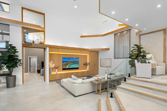living room featuring a high ceiling and recessed lighting