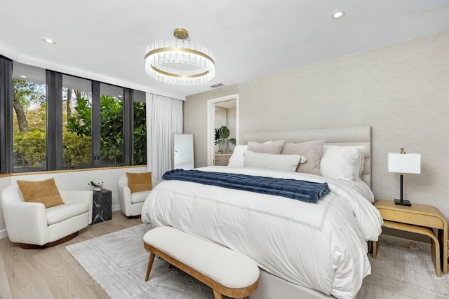 bedroom with recessed lighting, visible vents, baseboards, and wood finished floors