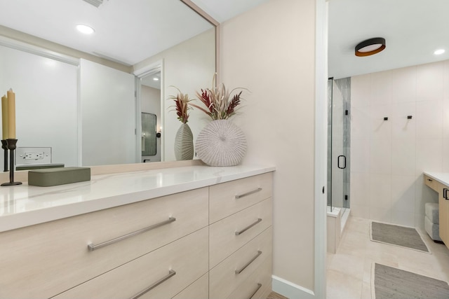 full bath with vanity, baseboards, recessed lighting, tile patterned floors, and a shower stall