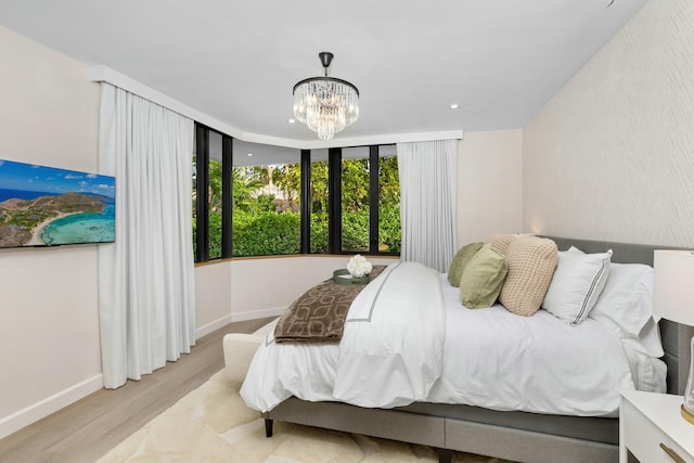 bedroom featuring a chandelier, recessed lighting, baseboards, and wood finished floors
