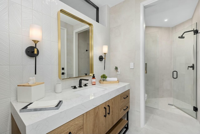 full bathroom featuring tasteful backsplash, vanity, a stall shower, toilet, and tile walls