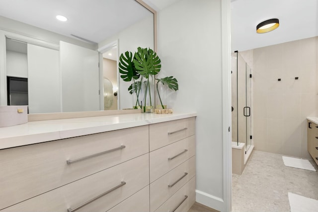 full bathroom with a stall shower, vanity, and recessed lighting