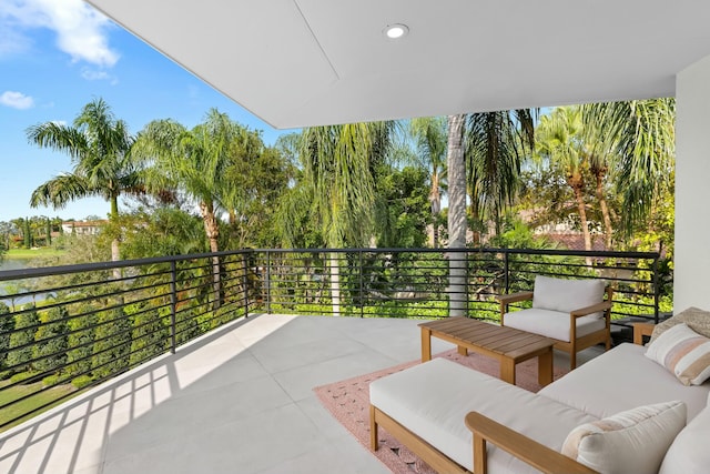 view of patio featuring outdoor lounge area and a balcony