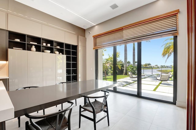 dining space featuring light tile patterned flooring