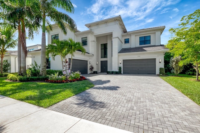 view of front of home with a front lawn, decorative driveway, and stucco siding