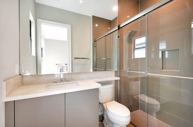 full bathroom with toilet, a shower stall, and vanity