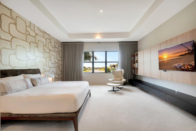 carpeted bedroom featuring a raised ceiling