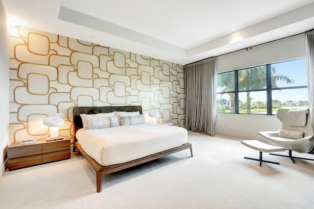 carpeted bedroom featuring an accent wall