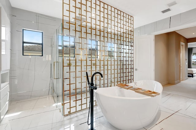 interior space with marble finish floor, visible vents, and tile walls