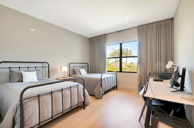 bedroom with light wood-style flooring and baseboards