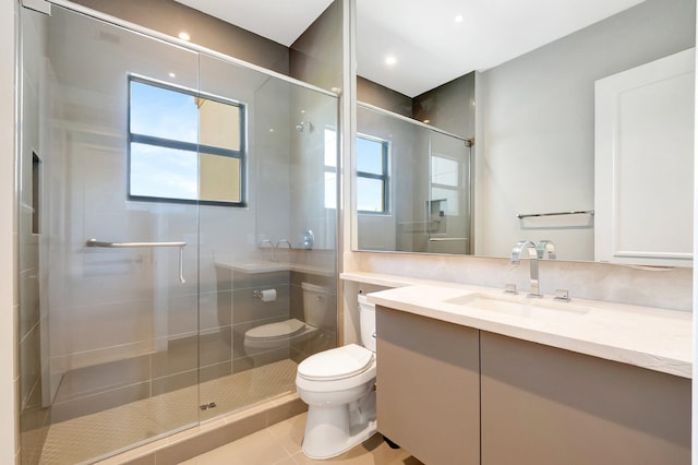 full bathroom featuring toilet, a stall shower, plenty of natural light, and vanity