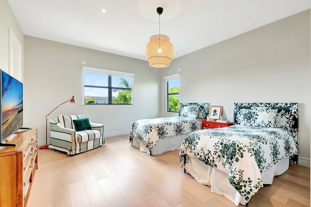 bedroom featuring baseboards and wood finished floors