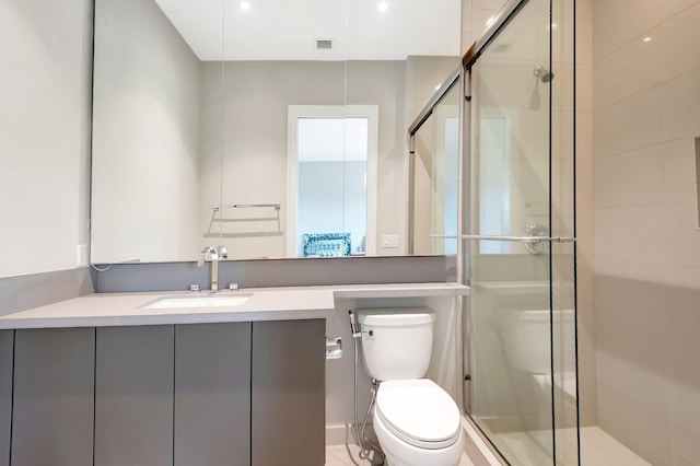 full bathroom featuring visible vents, a shower stall, toilet, and vanity