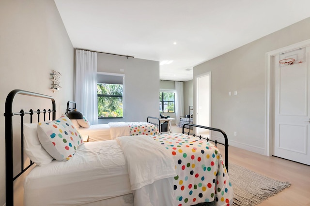 bedroom featuring baseboards and wood finished floors