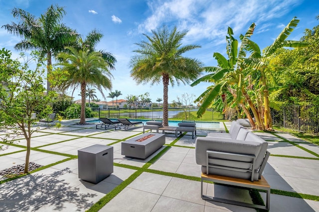 view of home's community with a patio, a pool, a water view, an outdoor fire pit, and fence