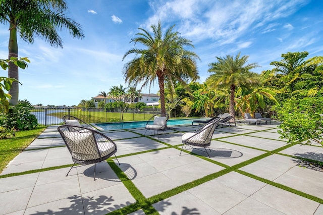 view of swimming pool featuring a patio area, fence, and a fenced in pool