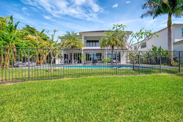 view of pool featuring a yard, fence, and a fenced in pool