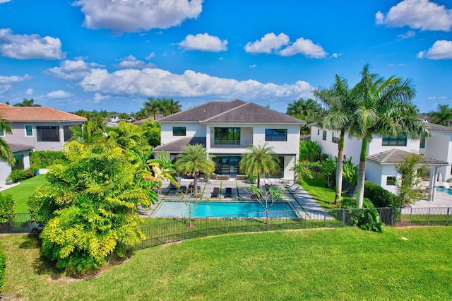 back of house with a yard, a patio area, a fenced backyard, and a fenced in pool