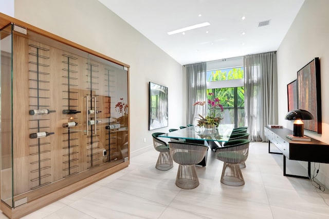 dining room with light tile patterned floors, baseboards, and visible vents