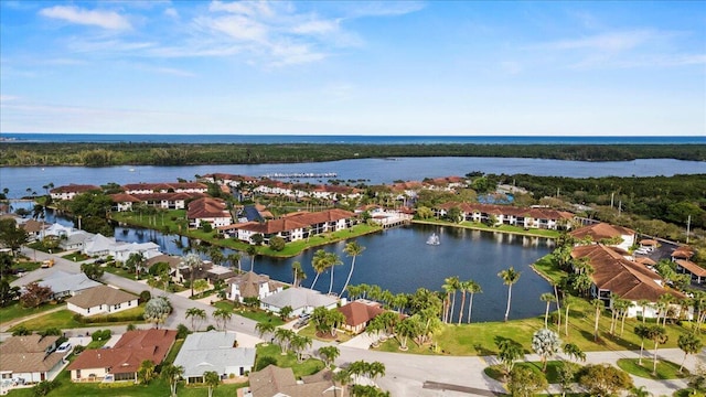 drone / aerial view with a residential view and a water view