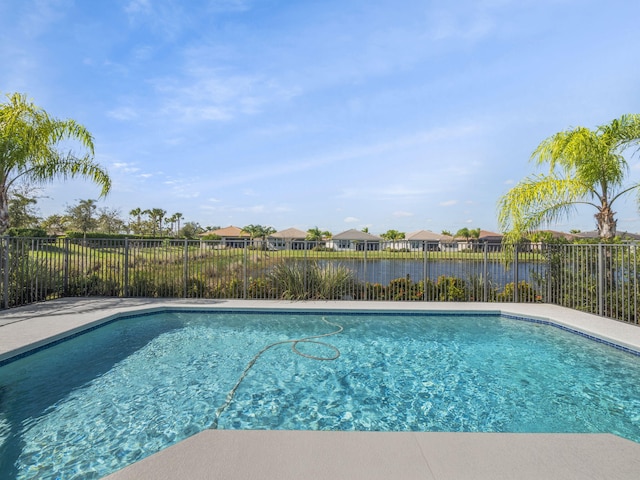 view of pool featuring a water view, a fenced backyard, and a fenced in pool