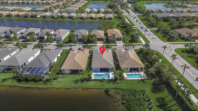 bird's eye view with a residential view and a water view