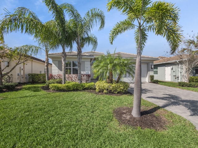 single story home with concrete driveway, a front lawn, and an attached garage