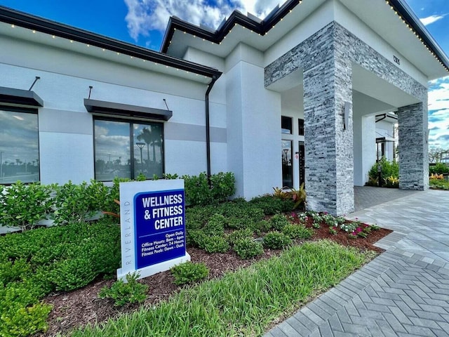 exterior space with stone siding and stucco siding