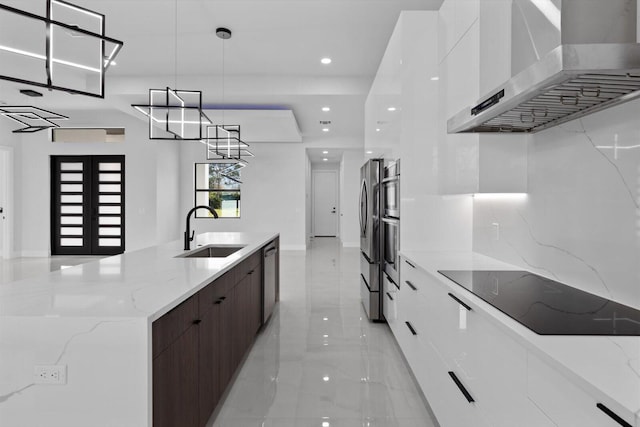 kitchen with sink, ventilation hood, white cabinets, hanging light fixtures, and dark brown cabinets