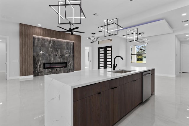 kitchen featuring a spacious island, sink, hanging light fixtures, and dishwasher