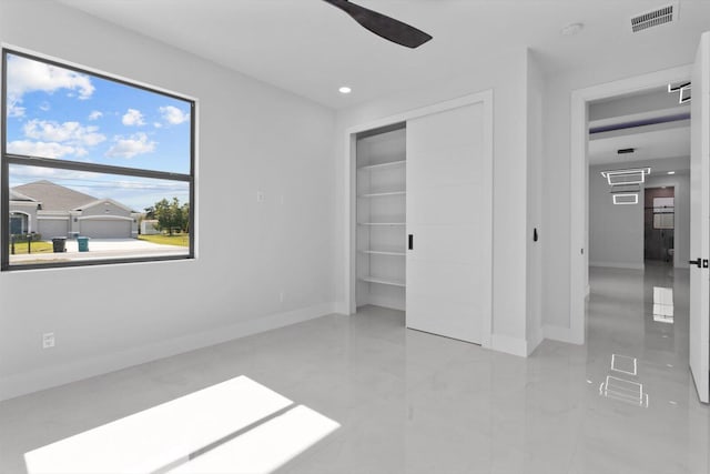 unfurnished bedroom featuring ceiling fan and a closet