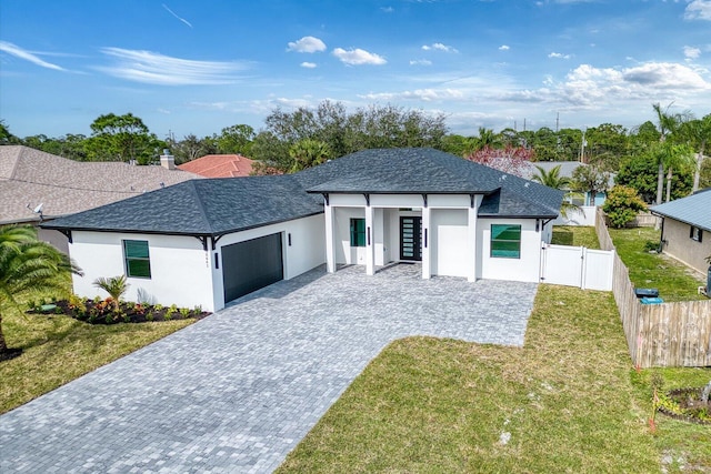 view of front of home featuring a front yard and a garage