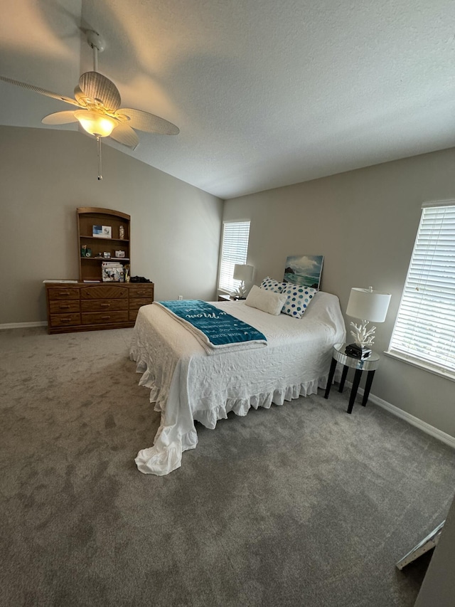 bedroom with carpet floors, vaulted ceiling, ceiling fan, a textured ceiling, and baseboards