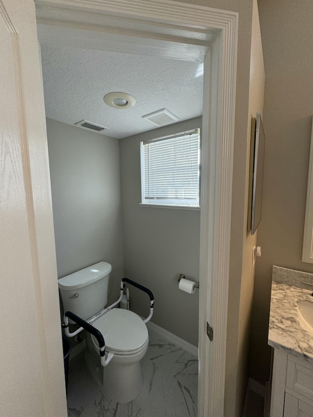 bathroom with visible vents, marble finish floor, vanity, and toilet