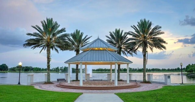 view of property's community featuring a gazebo, a yard, a water view, and fence