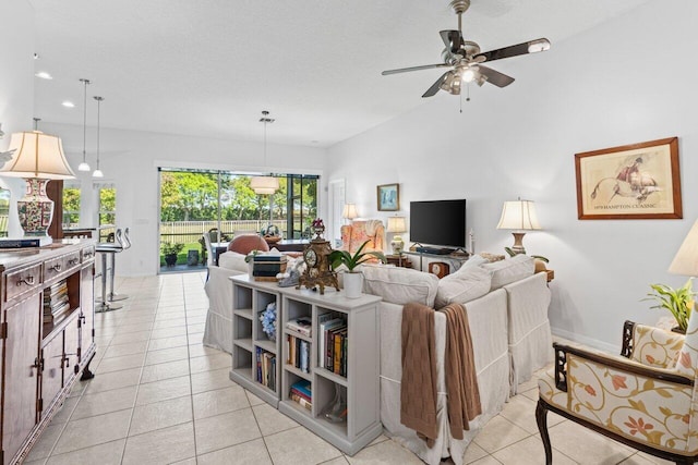 living room featuring light tile patterned floors, a textured ceiling, baseboards, and a ceiling fan