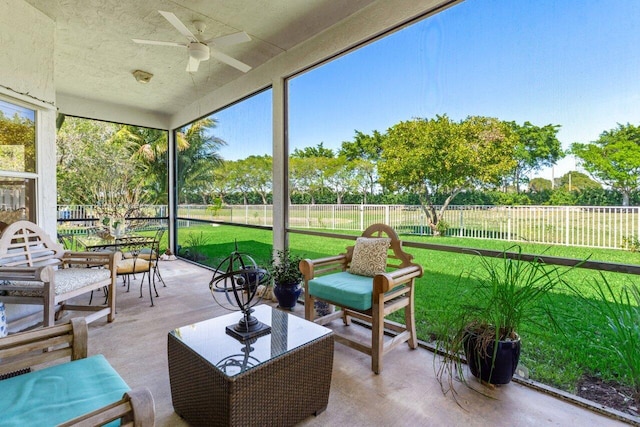 sunroom with plenty of natural light and ceiling fan