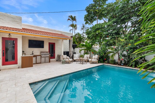 view of pool with a patio area, fence, a fenced in pool, and area for grilling