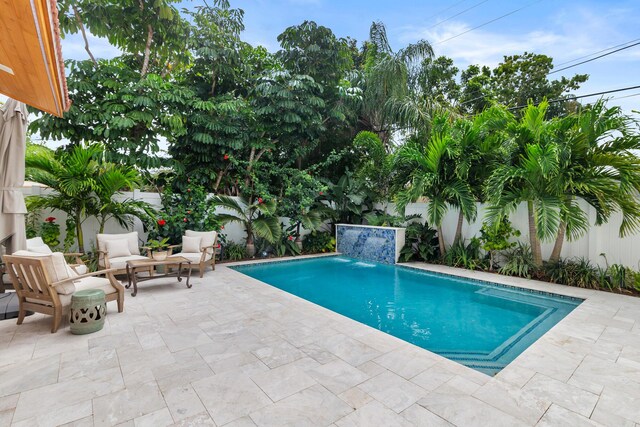 view of pool with a fenced in pool, a patio area, a fenced backyard, and an outdoor living space