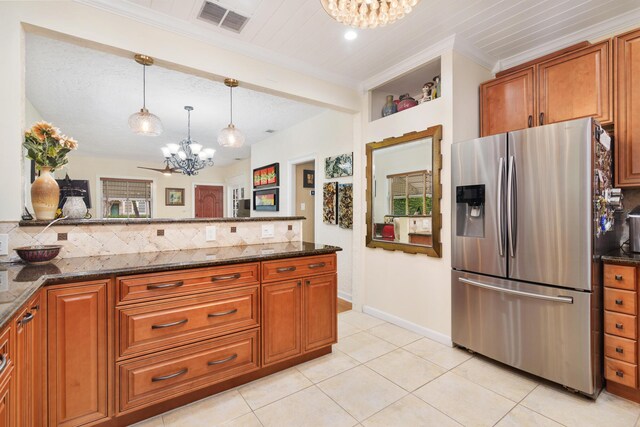 kitchen featuring decorative light fixtures, visible vents, an inviting chandelier, dark stone countertops, and stainless steel fridge with ice dispenser