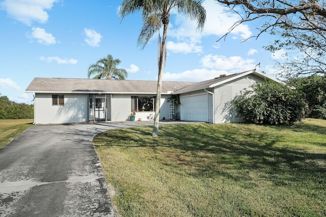 ranch-style house featuring a front lawn and a garage