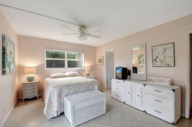 tiled bedroom featuring a textured ceiling and ceiling fan