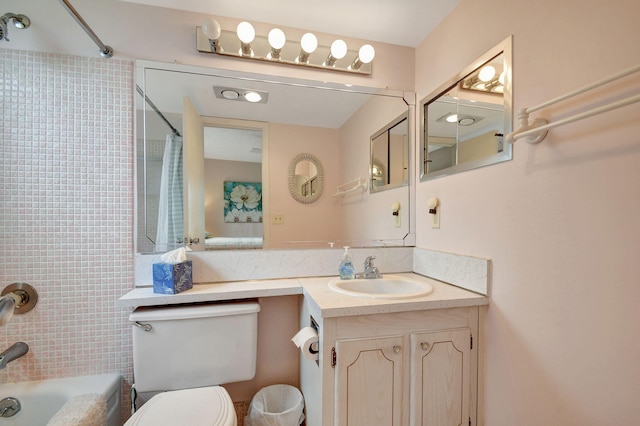 full bathroom featuring toilet, shower / bathtub combination with curtain, and vanity