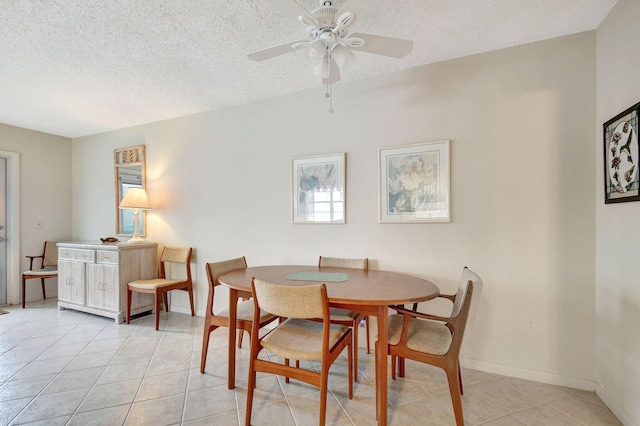 tiled dining space with plenty of natural light, ceiling fan, and a textured ceiling