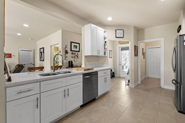 kitchen with white cabinets, appliances with stainless steel finishes, sink, and kitchen peninsula