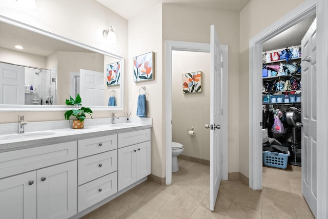 bathroom with vanity, tile patterned flooring, toilet, and a shower