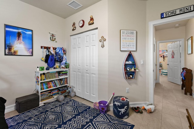 game room with light tile patterned flooring