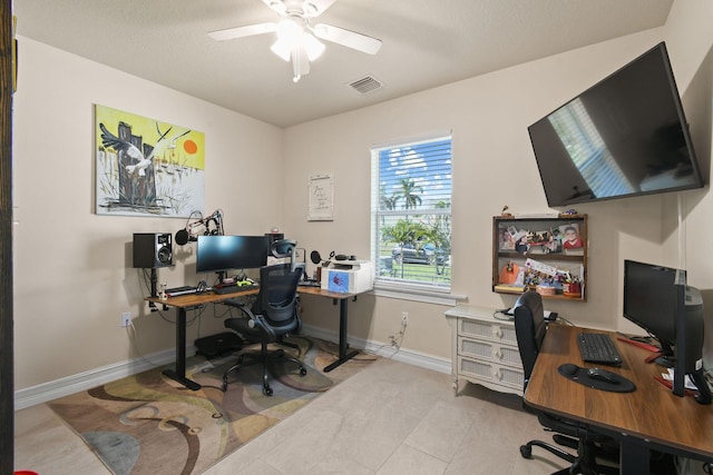 tiled office space with ceiling fan